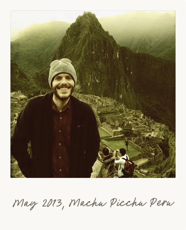 Chris smiling in front of the Taj Mahal during his year of solo backpacking