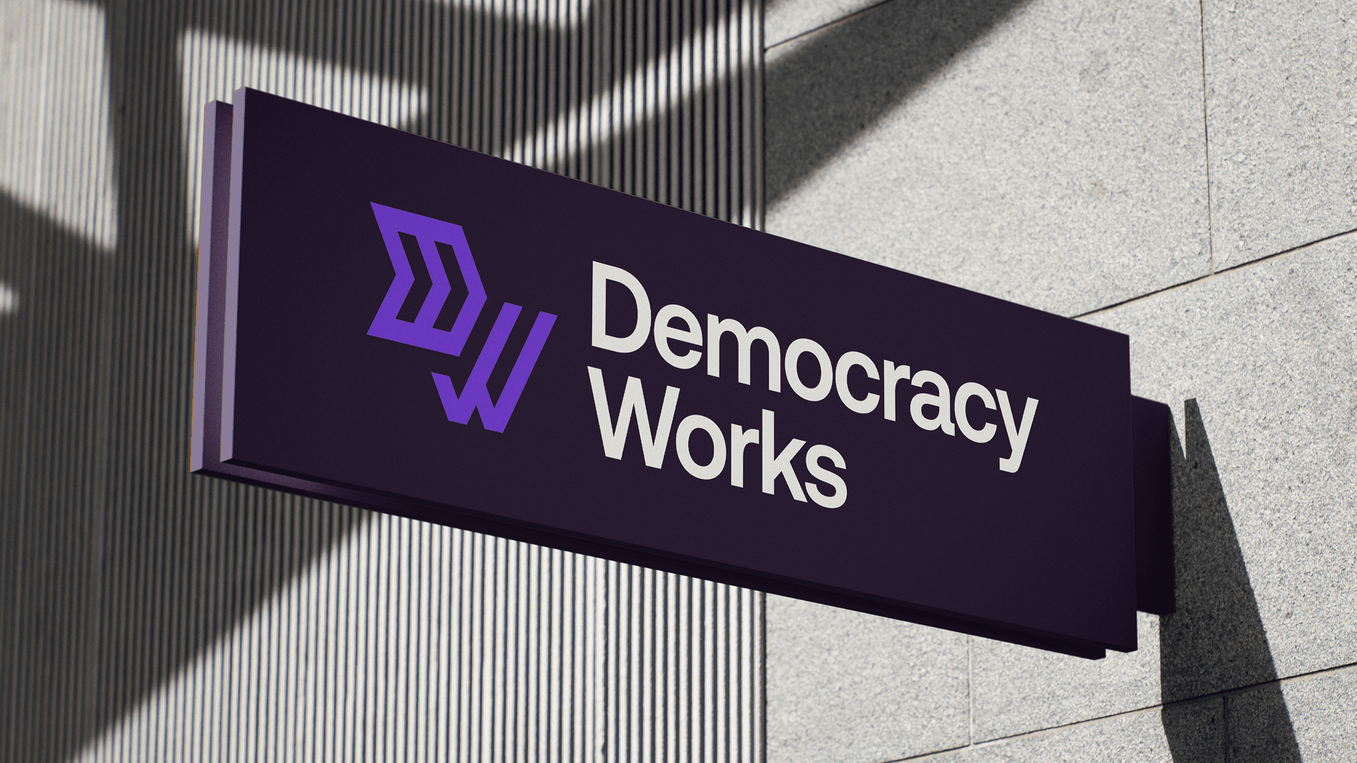 Democracy Works exterior office sign mounted to a building